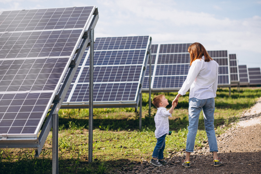 mother and child in a field of solar panels